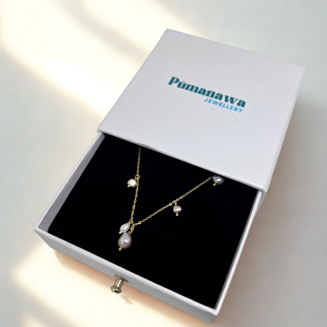 Jewelry set in a white box with 'Pumanawa Jewellery' branding on a light background